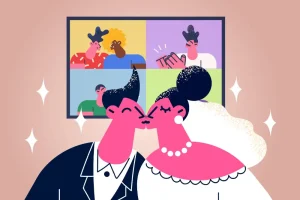 Newlyweds kiss while virtual guests rejoice on the screen