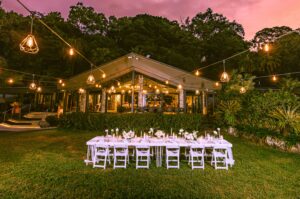 Trinity Beach Palace front view at dusk with a wedding reception setup on the front lawn