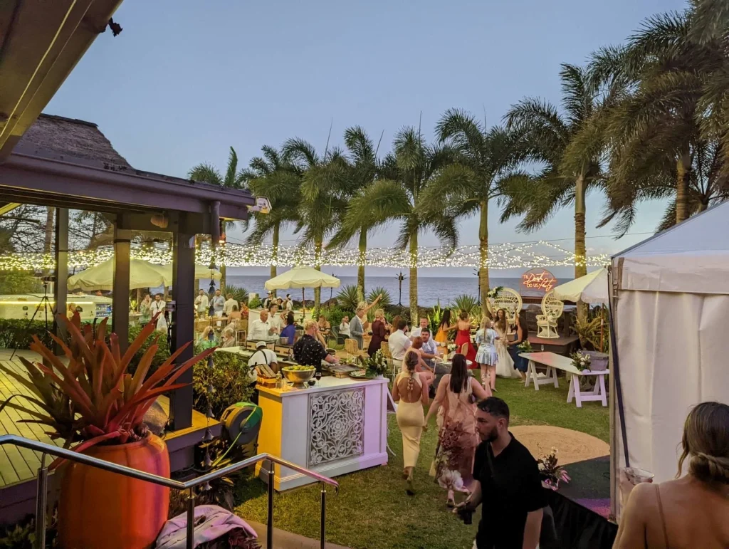 Wedding ceremony at sunset with several guests