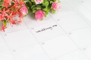 Wedding date marked on a calendar with flowers on the side