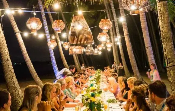 Long dining table for a large group of guests at a wedding reception