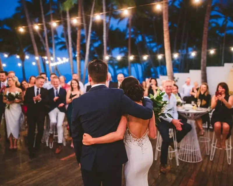 Newly married couple faces their guests at the reception