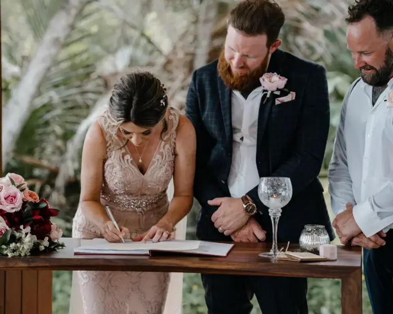 Bride and groom sign their marriage certificate at Alamanda Chapel