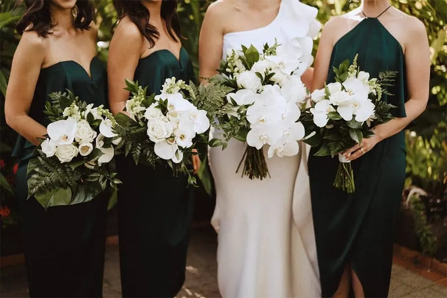 Bride and bridesmaids holding white bouquets