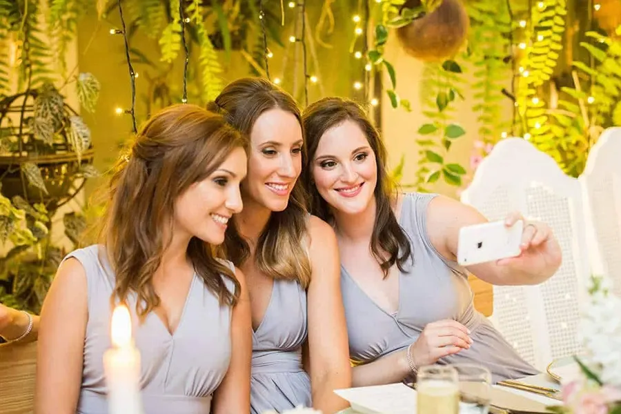 Three bridesmaids taking a selfie during a wedding party