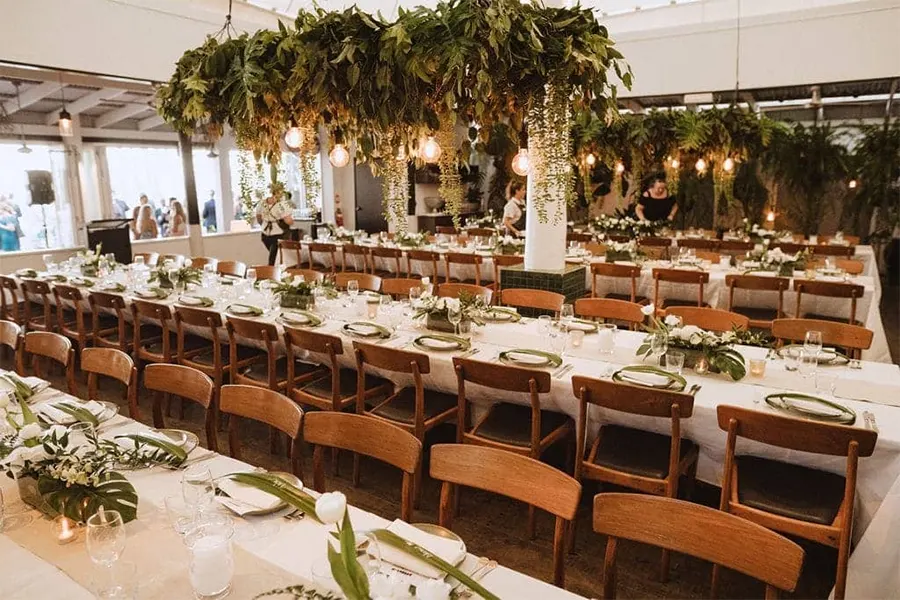 Rows of classic wooden chairs for the wedding reception