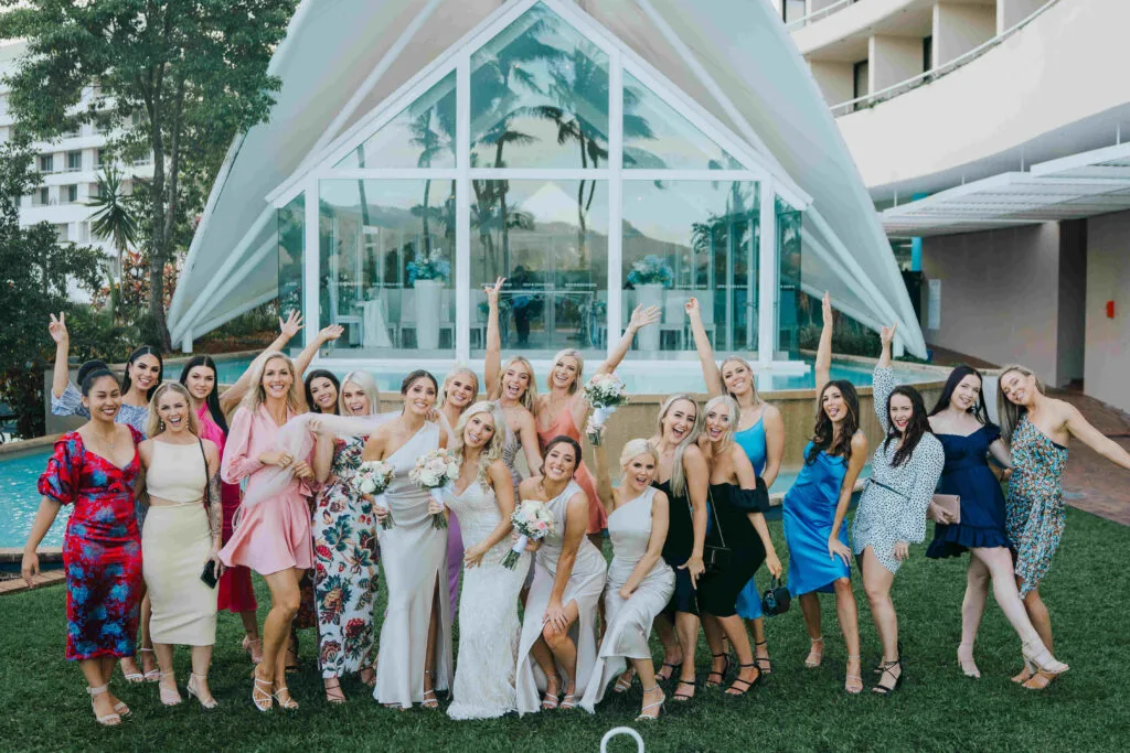 bridal party on landscaped garden in front of hilton blue horizon chapel