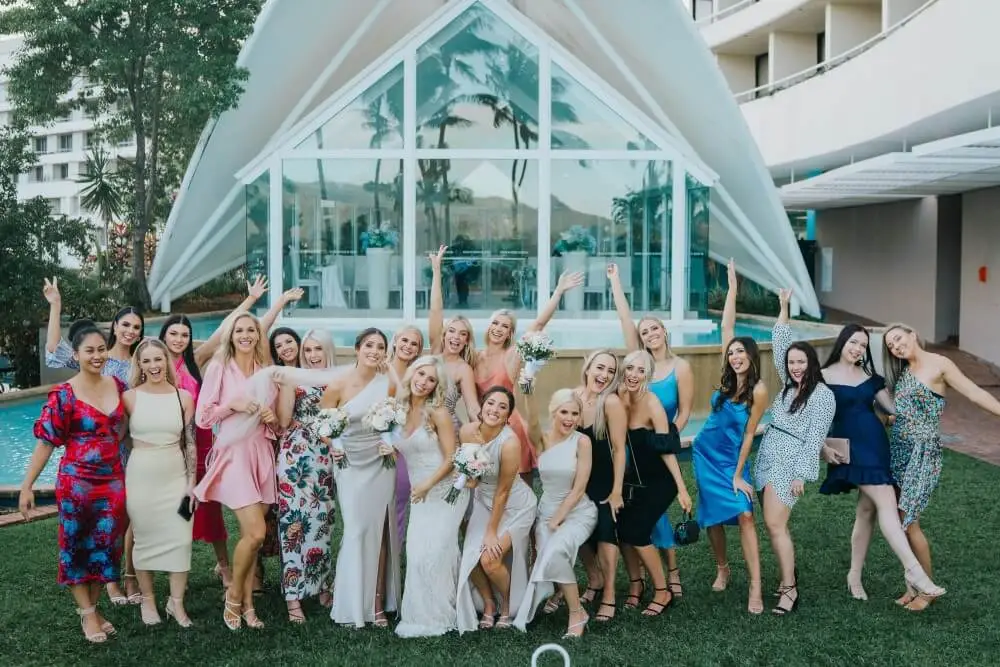 bride and friends posing in front of the Hilton Blue Horizon chapel