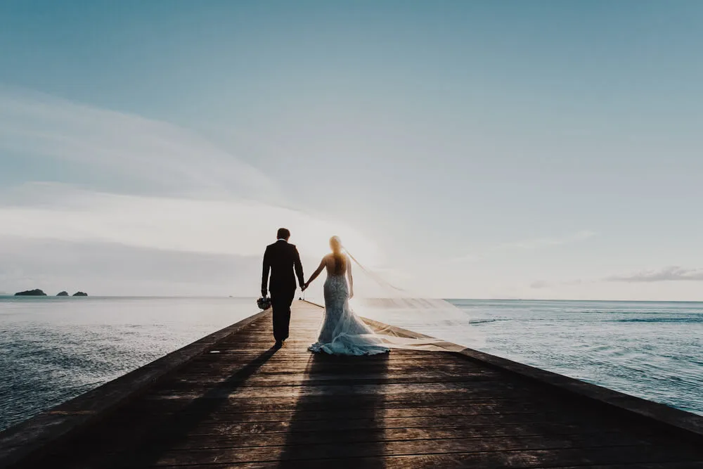 Newlywed couple enjoying the sunset view after getting married