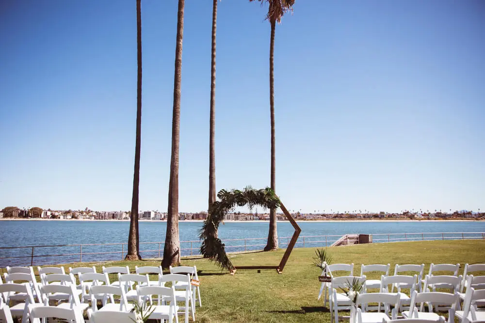 wedding arch and chairs setup on waterfront
